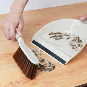 brush and broom sweeping the table