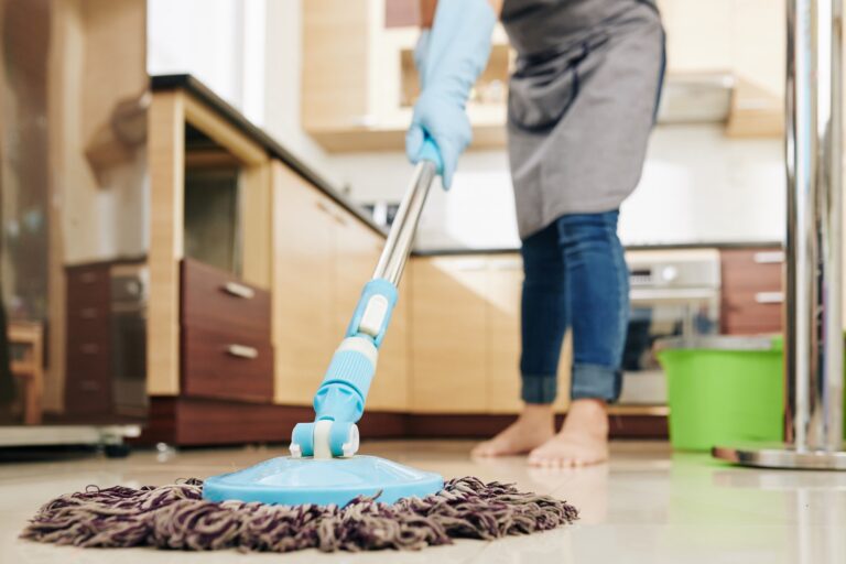 Housewife mopping kitchen