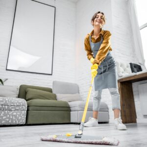Housewife portrait with a mop indoors
