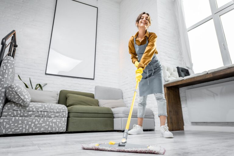 Housewife portrait with a mop indoors